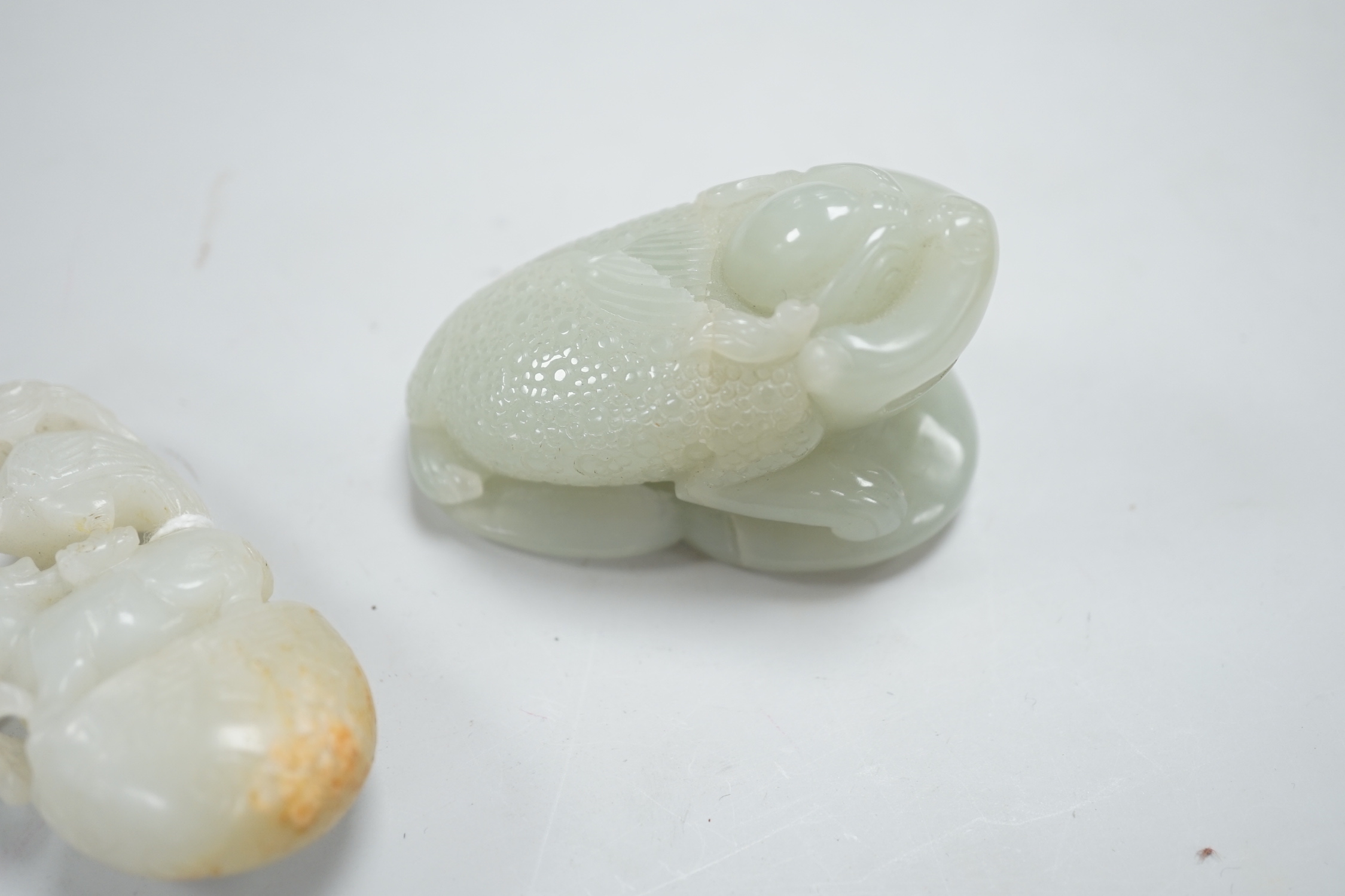 A Chinese green jade figure of a three legged toad and a Chinese pale celadon jade group of a crane and a deer in archaic style, toad carving 6.5cm long (2)